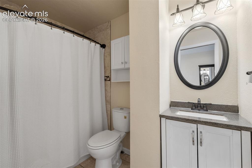 125 Diamond E Road Fountain, CO 80817 - Photo 19 of 43 a bathroom with a granite countertop sink mirror vanity and a toilet