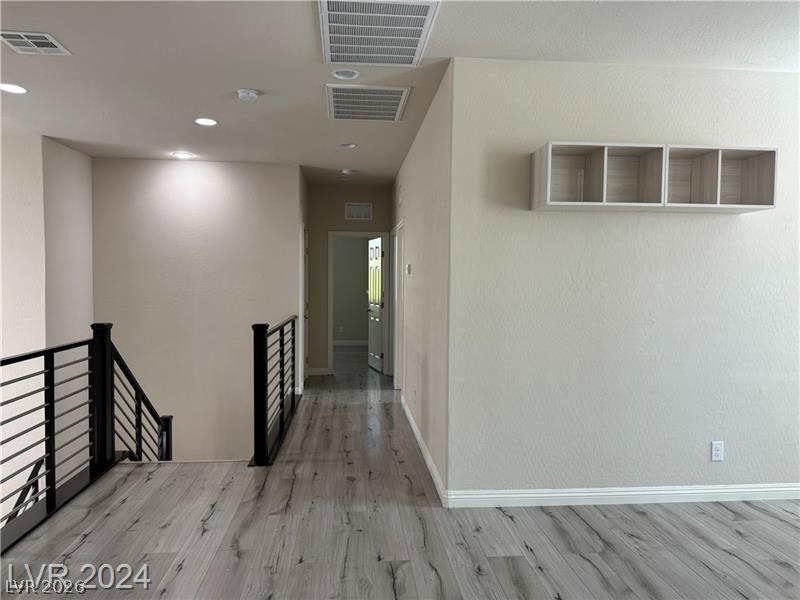 9056 Tony Ridge Avenue Las Vegas, NV 89148 - Photo 11 of 32 Clean lines define this bright interior, featuring sleek flooring and modern railing.