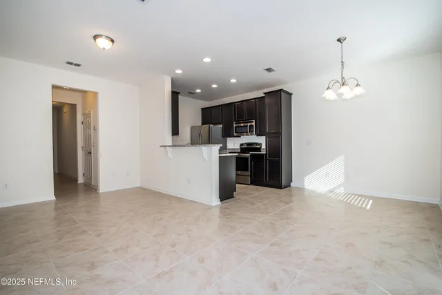 a view of kitchen and refrigerator