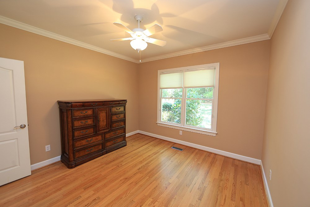 5800 Valley Mist Court Raleigh, NC 27613 - Photo 23 of 30 Hardwood floor, ceiling fan, crown molding Guest Bedroom
