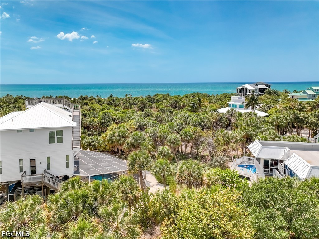 4491 Butterfly Shell Drive Upper Captiva, FL 33924 - Photo 19 of 27 a view of a terrace with a garden