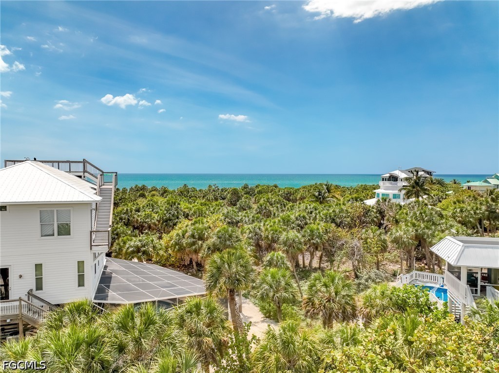 4491 Butterfly Shell Drive Upper Captiva, FL 33924 - Photo 23 of 27 a view of a patio with table and chairs and potted plants