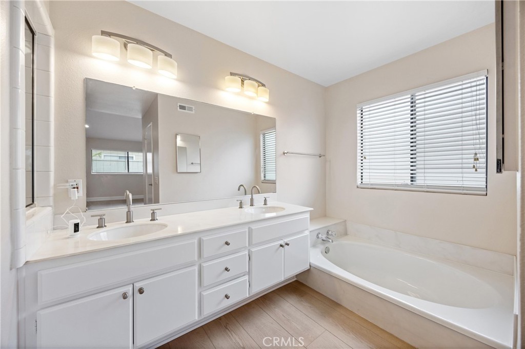 10 Coldstream, Unit 50 Irvine, CA 92604 - Photo 16 of 50 a bathroom with a tub a sink double vanity and a mirror
