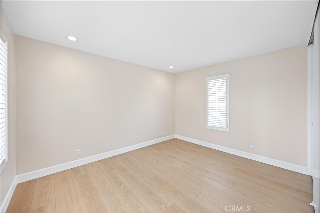 10 Coldstream, Unit 50 Irvine, CA 92604 - Photo 20 of 50 an empty room with wooden floor and windows