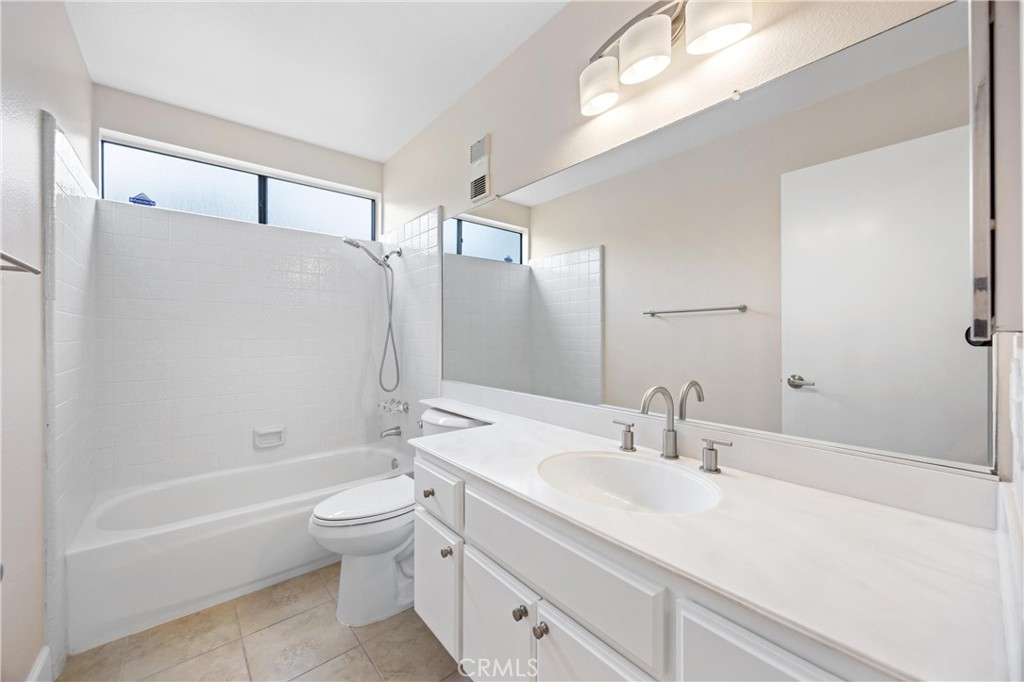 10 Coldstream, Unit 50 Irvine, CA 92604 - Photo 22 of 50 a bathroom with a granite countertop sink a toilet and shower