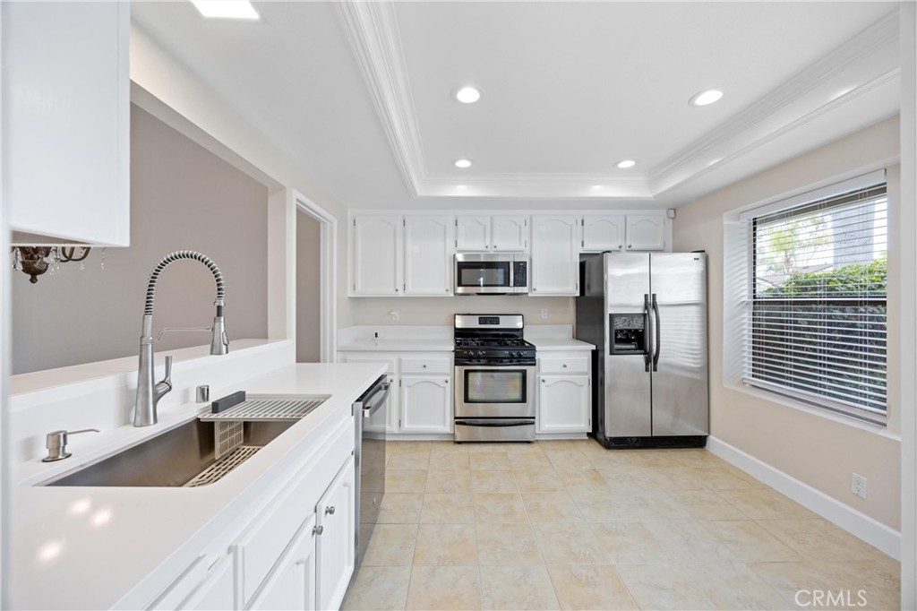 10 Coldstream, Unit 50 Irvine, CA 92604 - Photo 8 of 50 a kitchen with stainless steel appliances a refrigerator sink and microwave