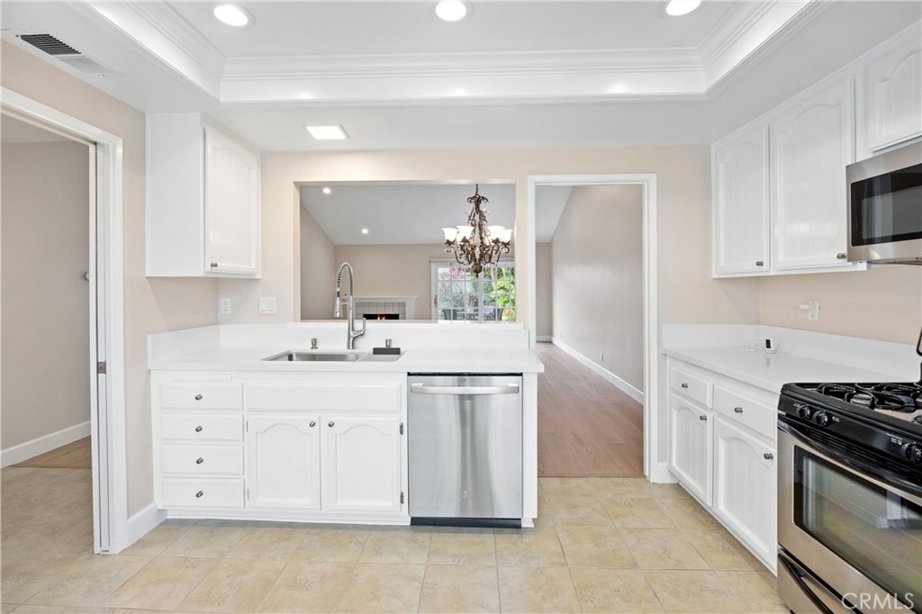 10 Coldstream, Unit 50 Irvine, CA 92604 - Photo 10 of 50 a kitchen with white cabinets and appliances
