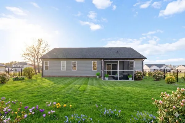 a brick house with garden in front of it