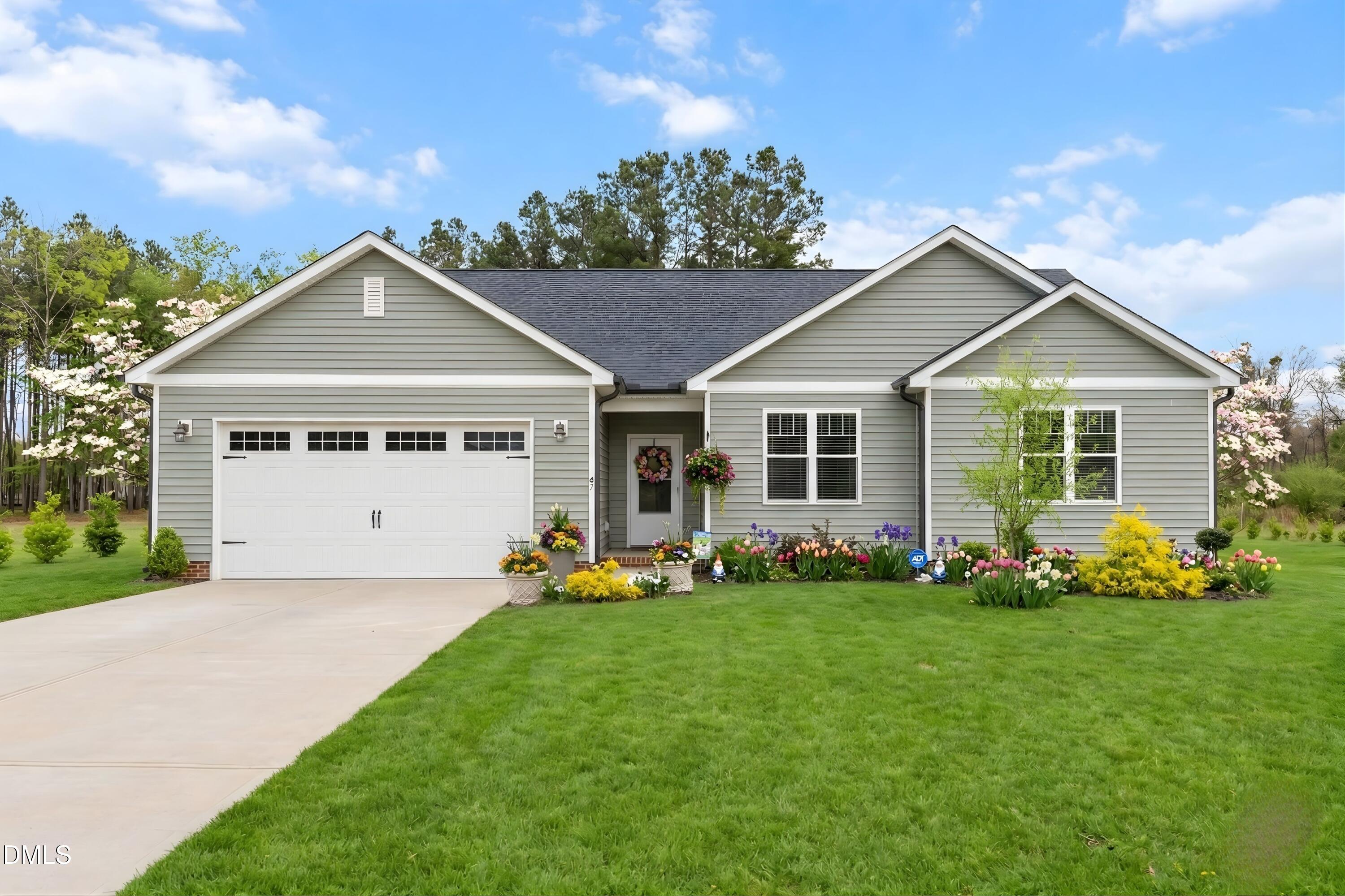 9159 Byron Court Bailey, NC 27807 - Photo 15 of 16 a front view of a house with a garden and porch