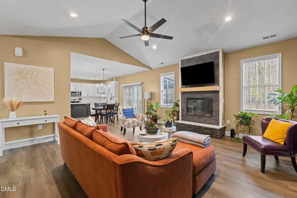 a living room with fireplace furniture and a flat screen tv