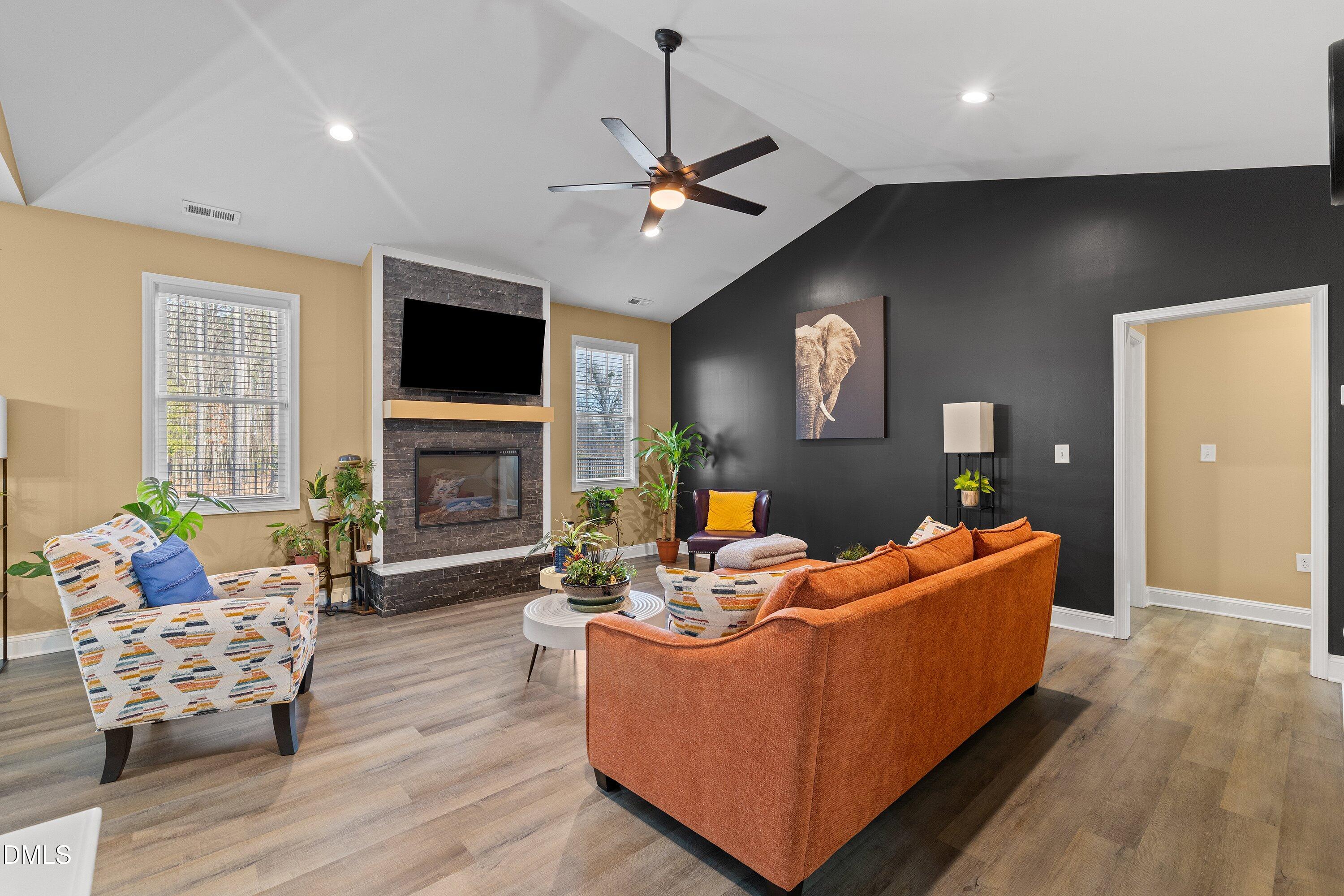 9159 Byron Court Bailey, NC 27807 - Photo 6 of 16 a living room with furniture fireplace and a flat screen tv