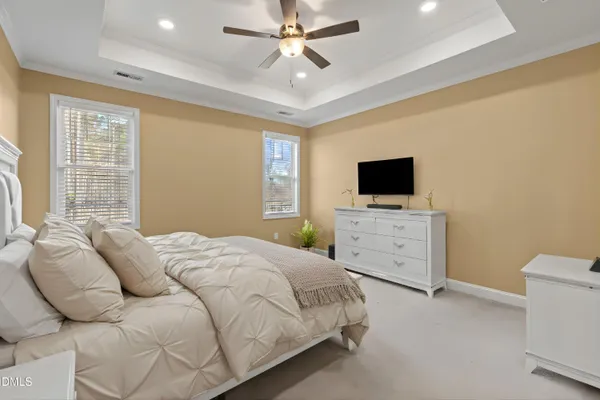 a bedroom with a large bed and a flat screen tv