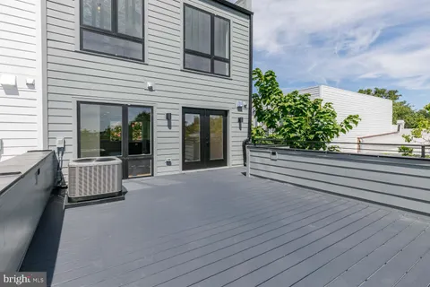 a view of a house with a floor to ceiling window and wooden floor