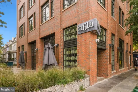 a view of a brick building with many windows