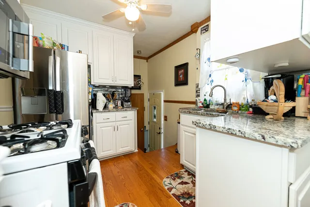 a kitchen with a sink appliances and cabinets