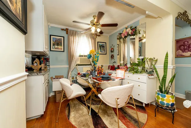 a view of a dining room with furniture and a chandelier fan