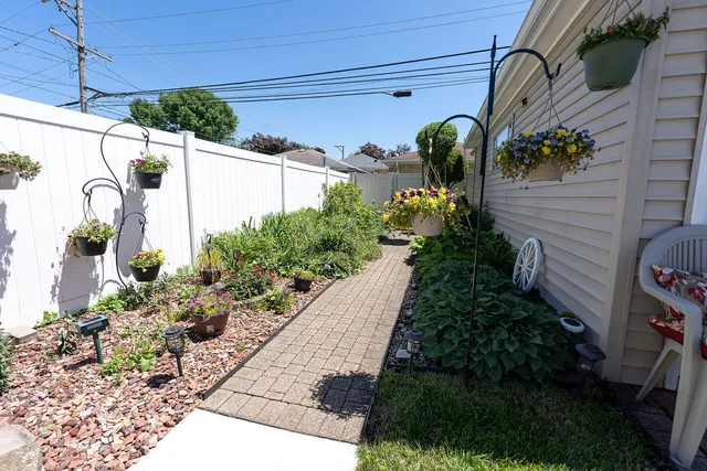 a vase of flowers sitting on a floor in front of a door