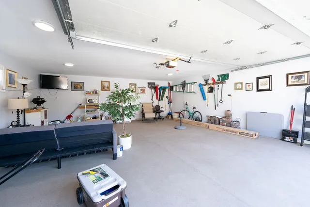 a living room with furniture and a gym