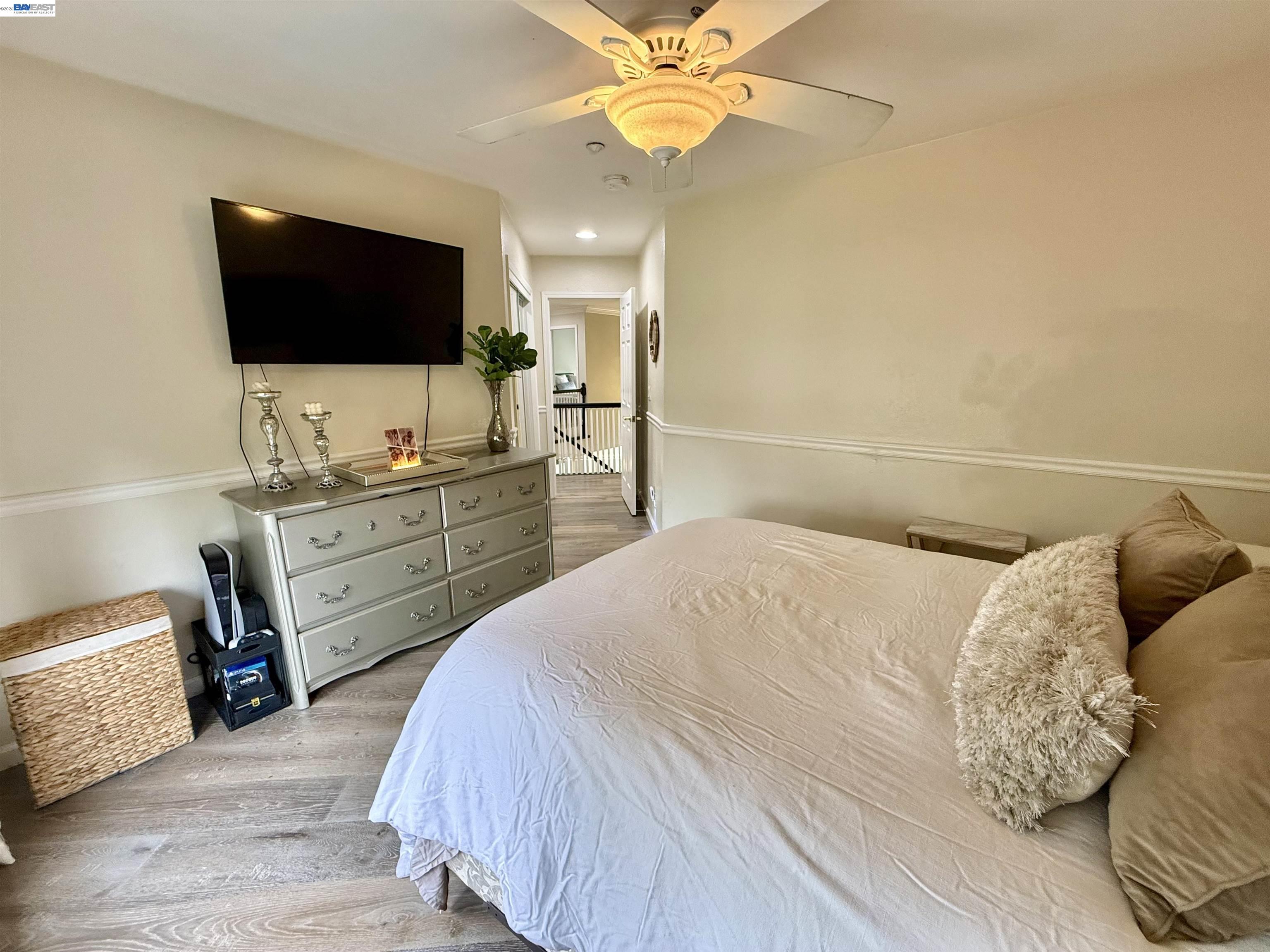 1284 Riesling Circle Livermore, CA 94550 - Photo 57 of 79 a bedroom with a bed and a flat screen tv