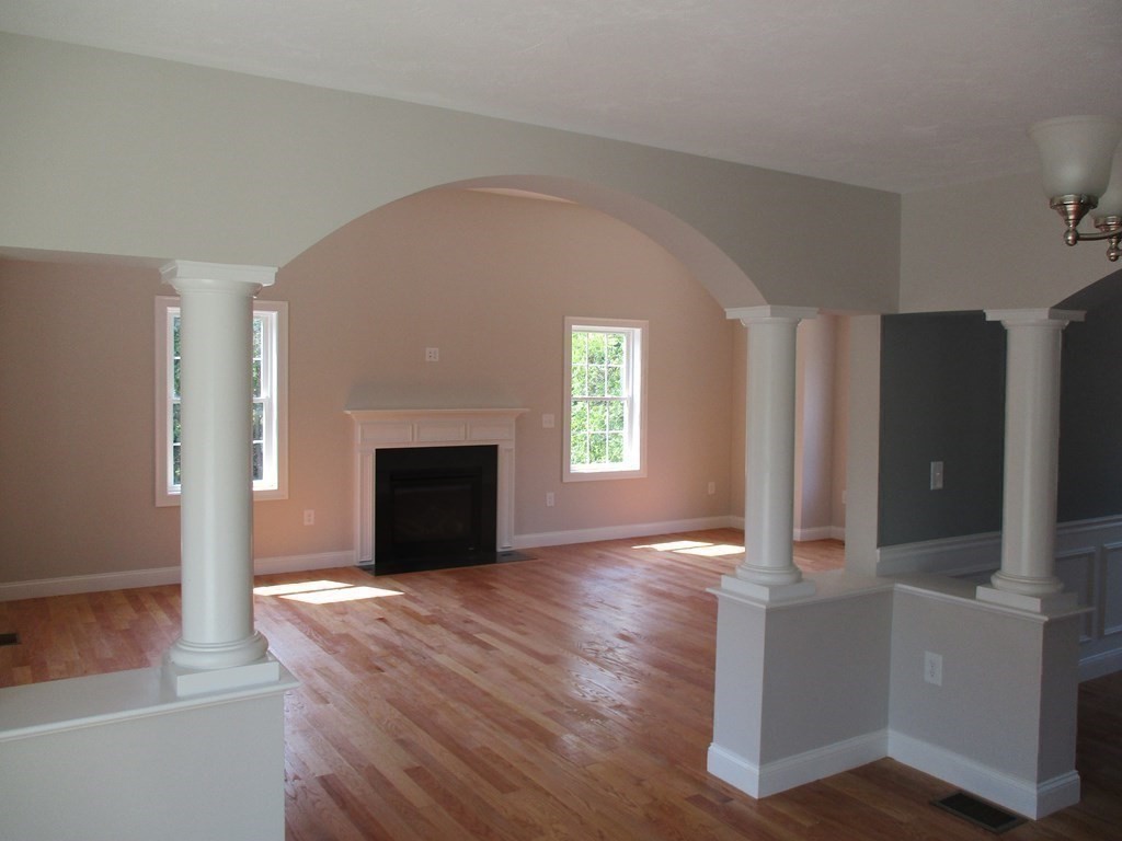 247 High Street Billerica, MA 01862 - Photo 14 of 26 a view of an empty room with a fireplace and a window
