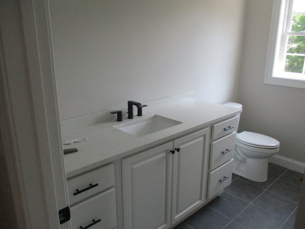 247 High Street Billerica, MA 01862 - Photo 18 of 26 a bathroom with a toilet sink and mirror