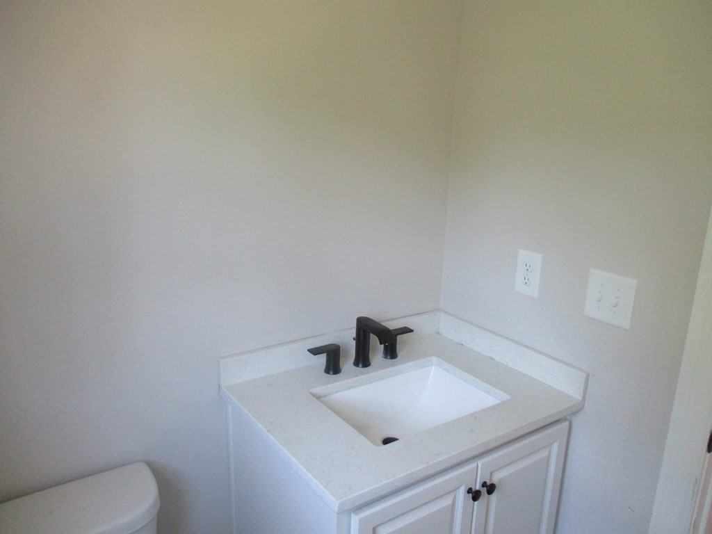 247 High Street Billerica, MA 01862 - Photo 22 of 26 a bathroom with a sink a toilet and vanity