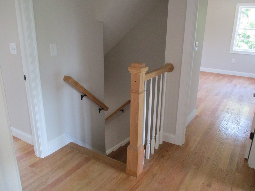 247 High Street Billerica, MA 01862 - Photo 24 of 26 a view of a hallway with wooden floor and stairs