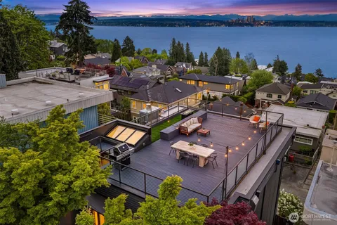 an aerial view of a house with outdoor space and lake view