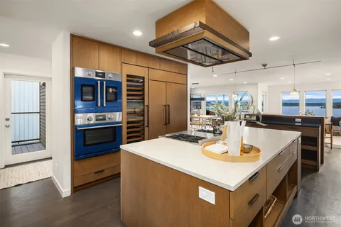 a kitchen with stainless steel appliances kitchen island granite countertop a sink and cabinets