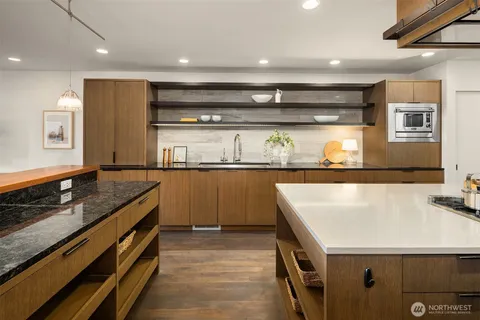 a kitchen with stainless steel appliances granite countertop a sink and cabinets