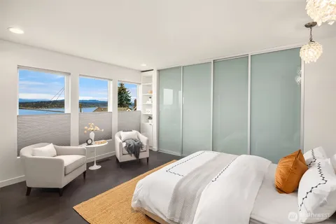 a bedroom with bed and wooden floor