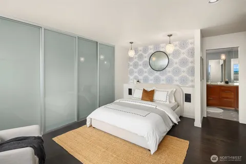 a bedroom with a bed and a chandelier