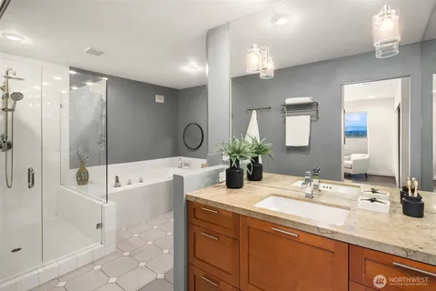 a bathroom with a tub sink and mirror