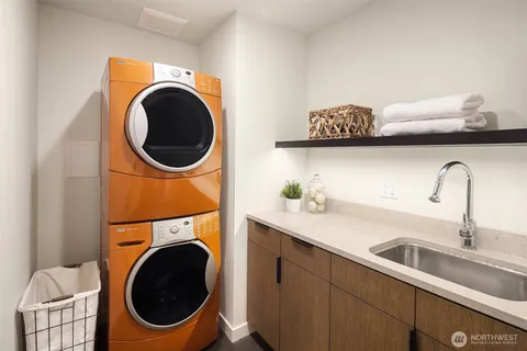 a utility room with sink dryer and washer