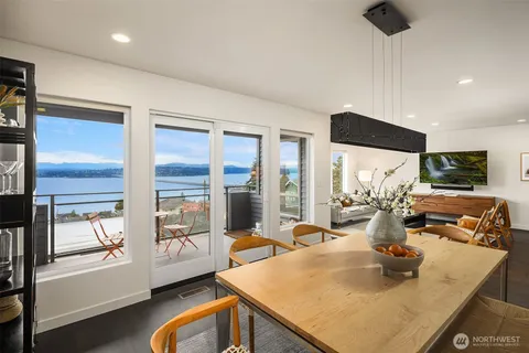 a kitchen with stainless steel appliances granite countertop sink stove and large window