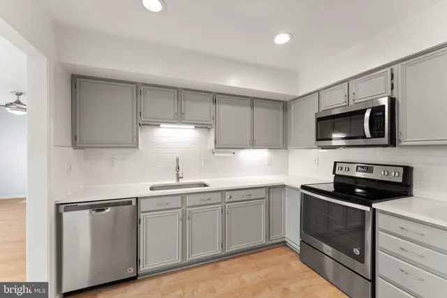 a kitchen with a sink stove and microwave