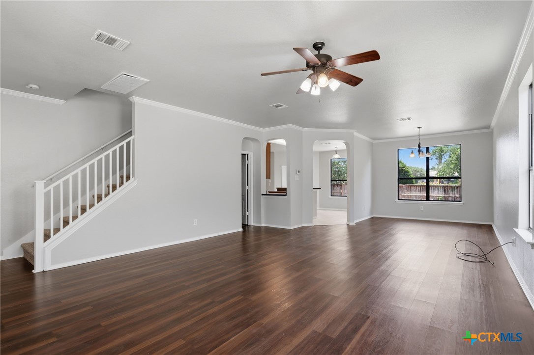 8716 Starview Street Temple, TX 76502 - Photo 5 of 36 Step inside to a welcoming, open-concept living area showcasing beautiful dark wood floors, crisp white trim, and plenty of natural light.