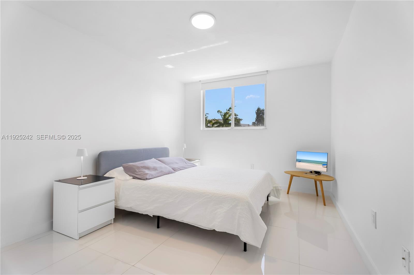 1688 West Avenue, Unit 401 Miami Beach, FL 33139 - Photo 14 of 20 a bedroom with a bed and a chair