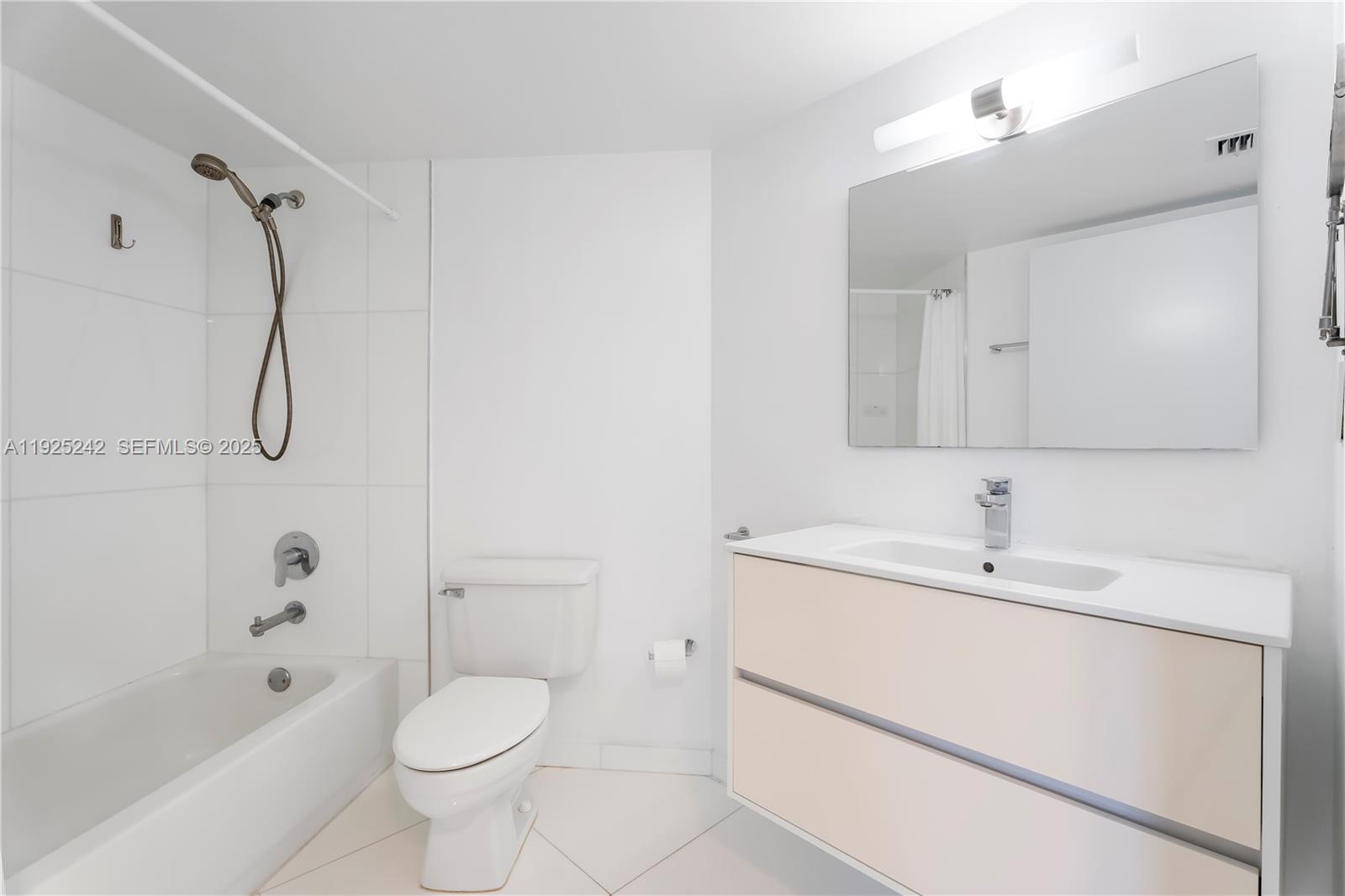 1688 West Avenue, Unit 401 Miami Beach, FL 33139 - Photo 15 of 20 a bathroom with a sink toilet a shower and bathtub