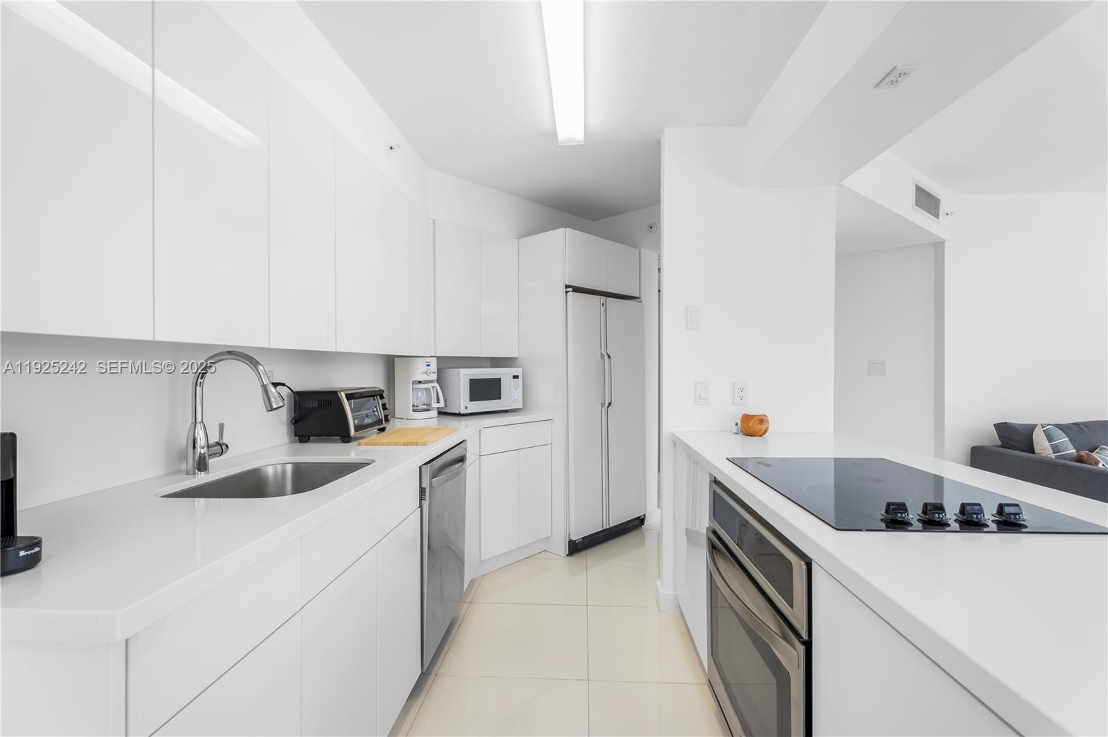 1688 West Avenue, Unit 401 Miami Beach, FL 33139 - Photo 2 of 20 a kitchen that has a sink and a stove