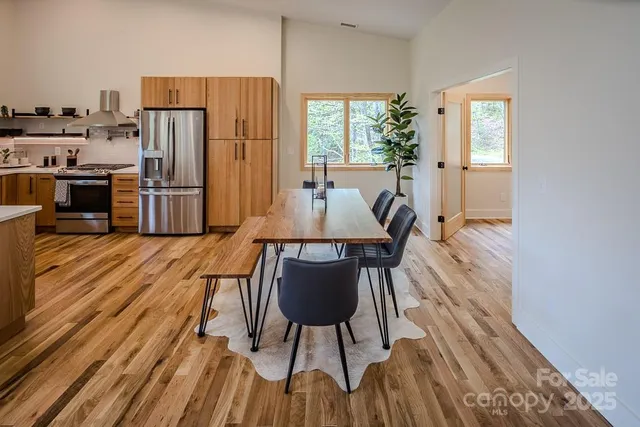 a dining room with furniture and wooden floor