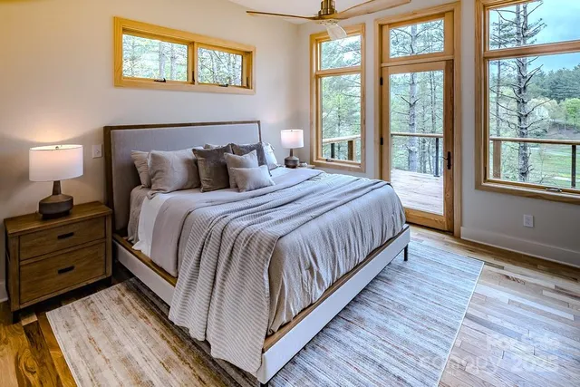 a large bed sitting in a bedroom next to a window