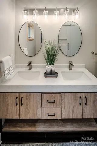 a bathroom with a sink a mirror and vanity