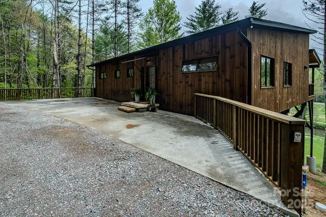 a view of a house with backyard and wall