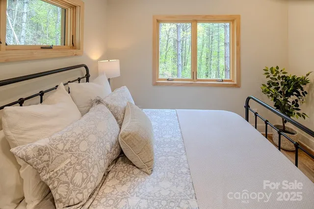 a bed sitting in a bedroom next to a window