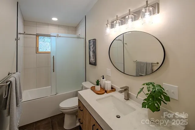 a bathroom with a sink toilet and a mirror