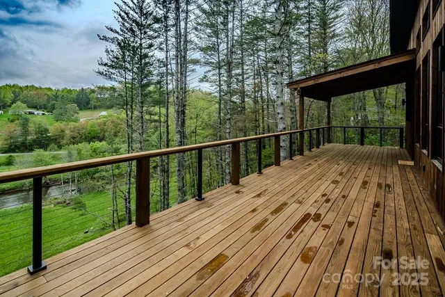 a view of balcony with floor to ceiling windows and wooden floor
