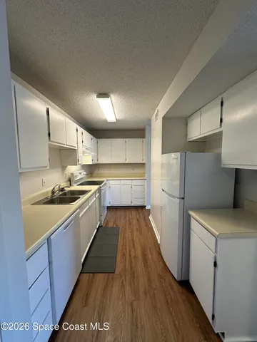 a large kitchen with a stove and a refrigerator