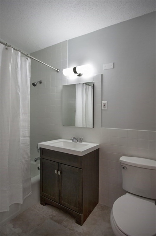 65 East India Row, Unit 10A Boston, MA 02110 - Photo 5 of 17 a bathroom with a toilet sink and mirror
