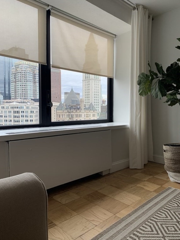 65 East India Row, Unit 10A Boston, MA 02110 - Photo 8 of 17 a living room with a large window